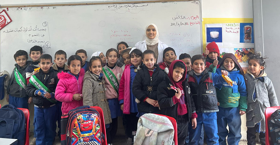 Photo of school staff with students in Jordan